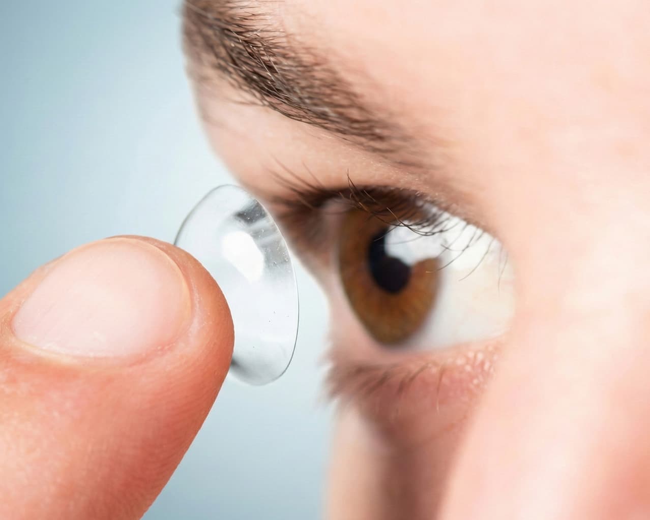 Spherical contact lens on fingertip